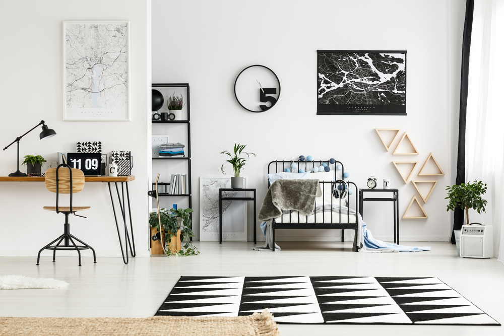 Black and white bedroom with workspace